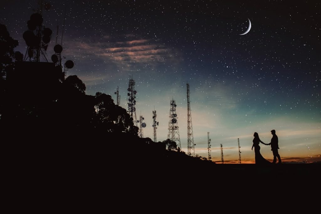 silhouette-of-two-person-under-half-mooon-fnhmp5q3la
